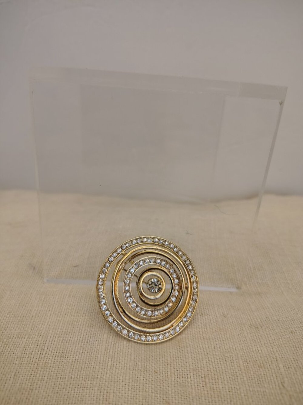 Polished Gold Tone Swirl Brooch with Rhinestones and large center Rhinestone